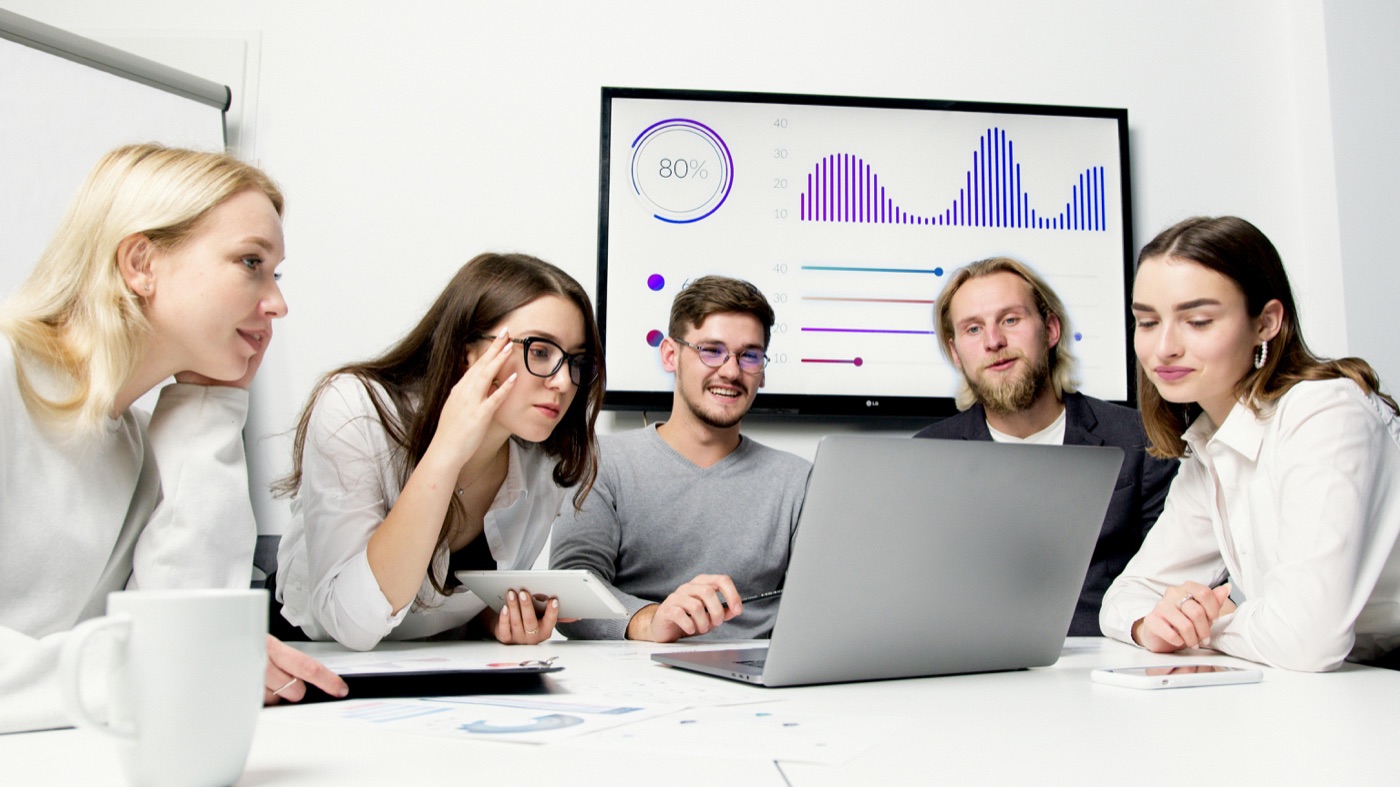 A leadership team reviewing financial dashboards together